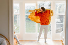 Load image into Gallery viewer, Maru wearing our Rust Crew neck made of natural organic cotton and recycled materials with our Organic Cotton joggers both in XL