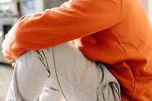 Load image into Gallery viewer, Maru wearing our Rust Crew and Track pants