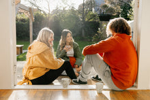 Load image into Gallery viewer, Maru wearing our Rust Crew neck made of natural organic cotton and recycled materials with our Organic Cotton joggers both in XL. Zoey wearing the Chloe layer in mustard size xs / small. Steph wearing the olive green Chloe Layer in XS / S