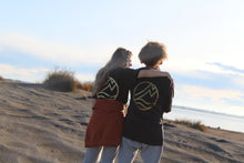 Load image into Gallery viewer, Zoey on beach wearing Origin Organic Cotton Joggers in a small. Certified, ethically made in factory powered by solar and wind energy