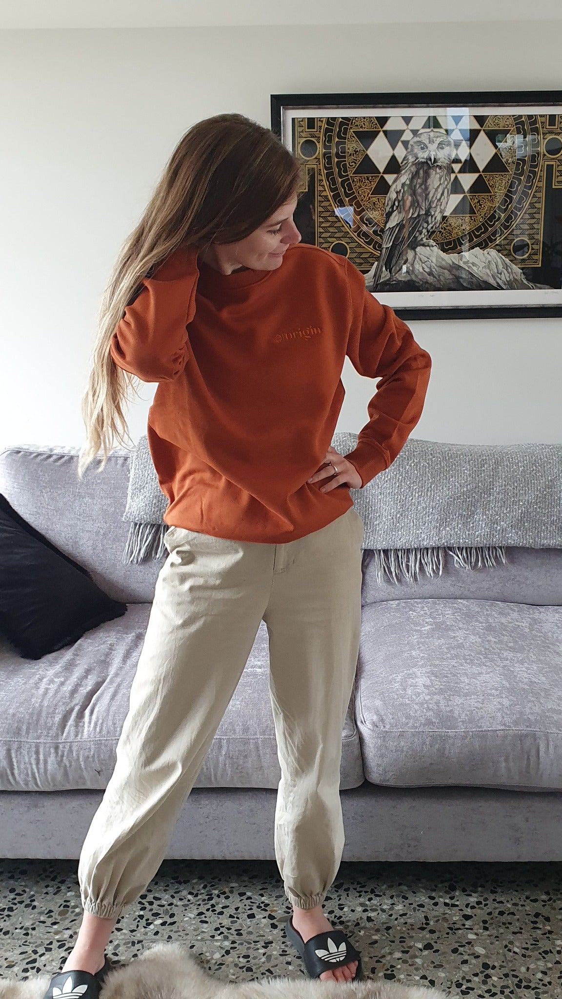 Here is Zoey sporting our Signature Rust Crew at home. This is made of Organic Cotton and Recycled polyester. Zoey wears a Medium so that she can fit a shirt or long sleeve comfortably underneath.