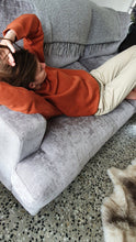 Load image into Gallery viewer, Here is Zoey sporting our Signature Rust Crew on the couch. This is made of Organic Cotton and Recycled polyester. Zoey wears a Medium so that she can fit a shirt or long sleeve comfortably underneath.
