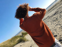 Load image into Gallery viewer, Here is Maru sporting our Signature Rust Crew on the beach. This is made of Organic Cotton and Recycled polyester. Maru wears a 2XL so that he can fit a shirt or long sleeve comfortably underneath.
