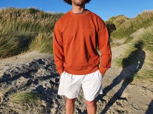 Here is Maru sporting our Signature Rust Crew on the beach. This is made of Organic Cotton and Recycled polyester. Maru wears a 2XL so that he can fit a shirt or long sleeve comfortably underneath.