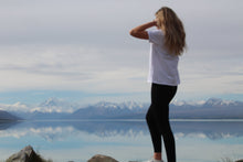 Load image into Gallery viewer, Zoey looking towards the mountains and Lake Pukaki. wearing Ribbed Dream Leggings. Zoey is wearing a size small/medium. These are mid to high waist, 4 way stretch. Super versatile , can be used for so many activities. They can be dressed up with a blazer and nice top, boots or cute little heel. They can be worn to work, the gym, the school run, yoga, coffee, groceries, parent teacher interviews, fashion show, hanging at home, marathons ... literally whatever the occasion are a dream!
